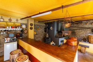 a kitchen with a wooden counter top in a room at Quinta do Borges 2 in Guarda