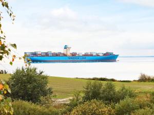 a large blue container ship on the water at Lakeview Hideaway - By Traum Ferienwohnungen in Ørby