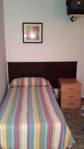Ein Bett oder Betten in einem Zimmer der Unterkunft Hotel Peralba