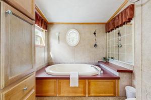 a bathroom with a large tub and a sink at Hillside Hideaway in North Woodstock +43 photos