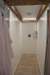 a bathroom with a shower with white walls at Chalúpka pod lesom Zázrivá in Zázrivá