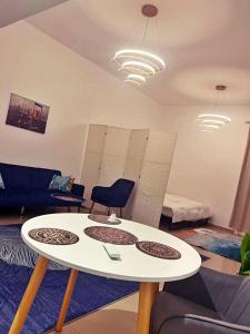 a living room with a white table and chairs at Boutique Studio , Guest Suit , AJMAN in Ajman 