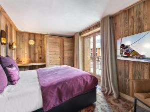 a bedroom with a bed and a large window at Appartement Duplex avec Terrasse, Jacuzzi et Cheminée - Val-d'Isère - FR-1-567-63 in Val dʼIsère