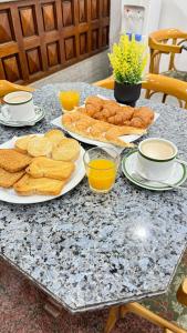 a table with plates of bread and cups of coffee at Diplomat Hotel in Buenos Aires +34 photos