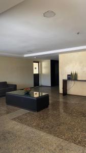a living room with a couch and a coffee table at Flat Vista Mar - Fortaleza in Fortaleza +12 photos