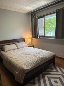 a bedroom with a large bed with a window at Mango Hostel - 420 Friendly in Bangkok
