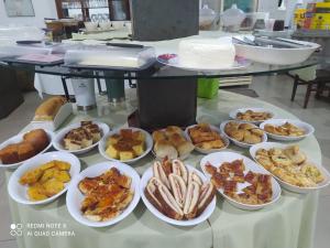 a bunch of plates of food on a table at Hotel Brasil in Miranda