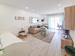 a living room with a couch and a table at Apartment Praia Rocha Tropical in Portimão