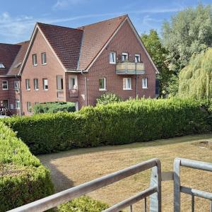 a house with a hedge in front of it at Apartmenthaus Gilden 1 in Borken