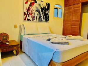 a bedroom with a bed with towels on it at Superior Basic Room With Swimming Pool Air Conditioning and Parking in Playa del Carmen +5 photos