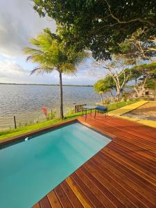 a swimming pool with a view of the water at Casa Josuá in Nísia Floresta