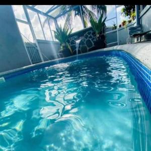a swimming pool with blue water in a building at La Casa Duncys Vacation in Kingstown