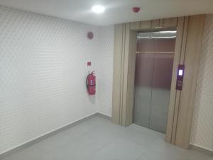 a room with a fire extinguisher on the wall at Elite Hotel KL Sentral in Kuala Lumpur