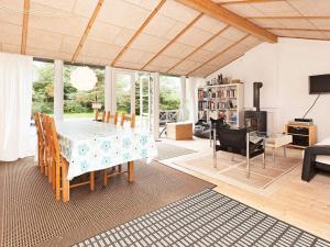 a living room with a dining room table and chairs at 6 person holiday home in Dronningmølle-By Traum in Dronningmølle
