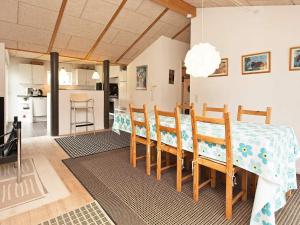 a dining room and kitchen with a table and chairs at 4 star holiday home in Dronningmølle in Dronningmølle