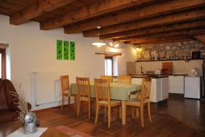 a kitchen and dining room with a table and chairs at Holiday Farmhouse Skvor in Robidišče +71 photos