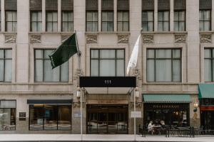a building with a flag on the front of it at Club Quarters Hotel Central Loop, Chicago in Chicago