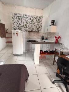 a kitchen with a refrigerator and a table in it at Pousada Maré Alta em Boipeba in Ilha de Boipeba +63 photos