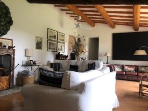 a living room with a couch and a tv at Wonderfull counrty villa, views on sea & Capalbio in Pescia Fiorentina
