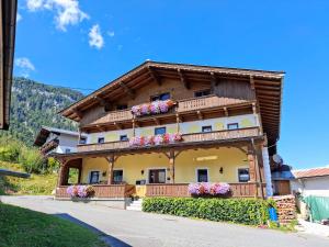 a house with flowers on the side of it at Lampererhof in Sankt Johann in Tirol