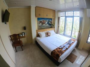 Ένα ή περισσότερα κρεβάτια σε δωμάτιο στο Homestay dan Cafe BungaSonsang +105 φωτογραφίες