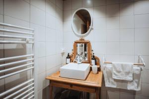 a bathroom with a sink and a mirror on a table at Chalet SALOON avec SPA privatif in Le Biot +18 photos