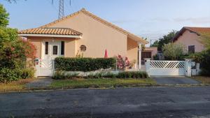 a house with a white fence in front of it at lepetitprince.aquitaine in Pessac