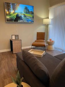a living room with a couch and a chair at Modern Comfort Near Colleges Perfect Mid Term Stay in Wilkes-Barre