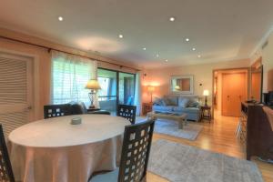 a living room with a table and a couch at Perfect Condo Sleeps 8 Private Community Florida in Palm Harbor