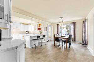 a kitchen and dining room with a table and chairs at Backyard Oasis in Bradford