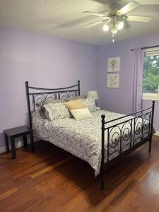a bedroom with a bed and a ceiling fan at Backyard Oasis in Bradford