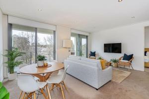 a living room with a couch and a table at Glebe Park Cityside with Style in Canberra