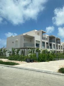 a large white building on the side of a street at Luxury 4BRs Penthouse Villa, Marassi in El Alamein +49 photos