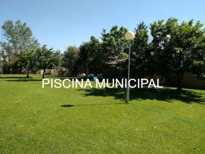 a sign in a field with a street light at Apartamentos Rural La Perla in Becilla de Valderaduey