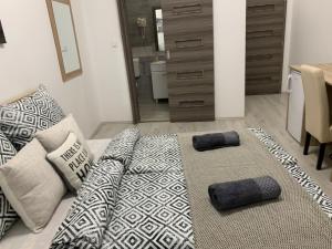 a living room with a couch and pillows on it at Cityhall Apartments in Miskolc
