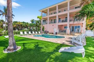 una casa con piscina e palme di Ocean Sands a Clearwater Beach