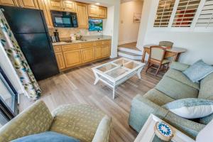 a living room with two couches and a table at Low Floor 1BR, Direct Oceanfront Beautiful, Pools! in Myrtle Beach