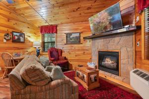 a living room with a couch and a fireplace at In Green Pastures Gatlinburg in Sevierville