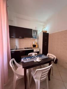 a kitchen with a table and chairs in a kitchen at Beb al porto da joseph in Trapani