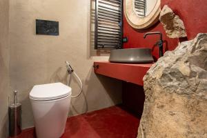 a bathroom with a white toilet and a sink at Casa Ancora in Carloforte