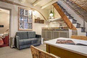 a living room with a couch and a table at Casa Ancora in Carloforte