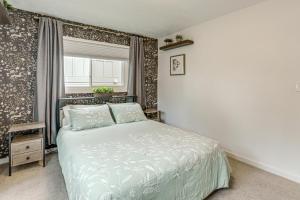 a bedroom with a bed and a window at Modern Wheat Ridge Home about 5 Mi to Dtwn Denver in Wheat Ridge
