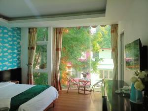 a bedroom with a bed and a large window at catba island hotel in Cat Ba