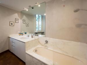 a bathroom with a tub and a sink and a mirror at LuxRent Penthouse Crimea in Turin +21 photos