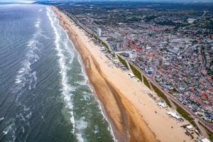 an aerial view of a beach and the ocean at The Dune house, Free parking in Zandvoort
