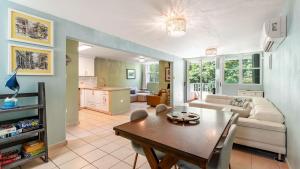 a living room with a table and a couch at Landing View 203 with private rooftop terrace in Rincon