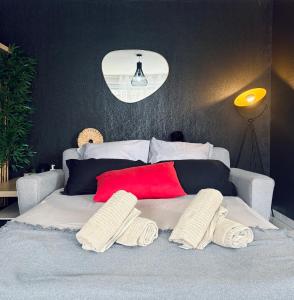 a bedroom with a white bed with two pillows at RedLounge - Appartement avec Piscine et Jardin in Toulouse +12 photos
