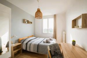 a bedroom with a bed and a chair and a window at Le Grandmont - 100m du parc - au pied de la faculté des sciences in Tours