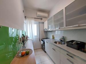 a kitchen with a bowl of fruit on a counter at Panpan Beach comfort home in Piraeus
