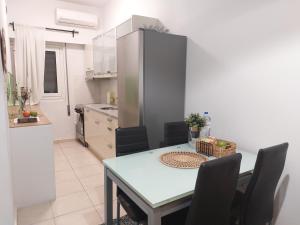 a kitchen and dining room with a table and chairs at Panpan Beach comfort home in Piraeus +13 photos